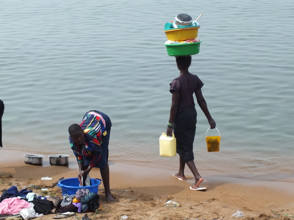 The stately gait of a heavily-laden women who has just finished her laundry, dishes and fetching water for cooking....and must now carry it back to her home.
