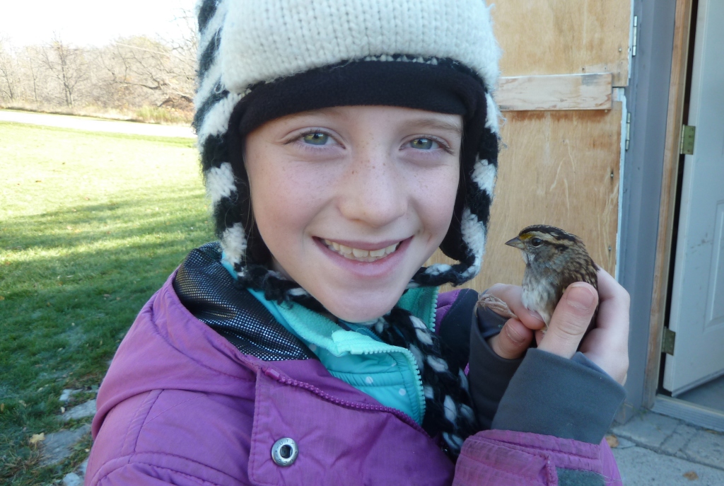 Clair with a White-throated Sparrow that she just banded.