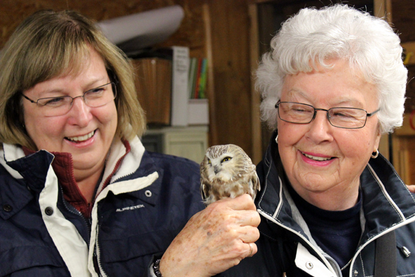 Diane and Dorothy obviously enjoying a Saw-whet. -B. Fotheringham